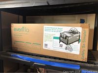 Box of Evenflo Portable BabySuite Deluxe Pack and Play showing front with branding and product details.