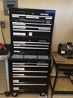 Front view of top chest and rolling cabinet with drawer labels