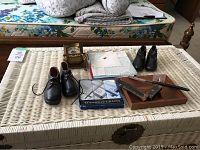 Photo showing exterior of a large wicker trunk with items on top not included.