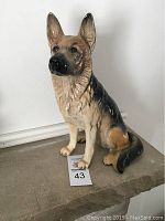 Front view of seated large Beswick German Shepherd dog figurine showing detailed glaze and colors.