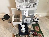 Full view of all home decor items including glassware, bowl set box, crystal vase, mug, night lights, decorative boxes, pitcher, candle, and other items.