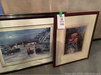 Two framed art prints side by side: left is winter village scene, right is female portrait; both have reddish-brown frames and mats.