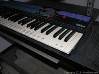Close-up photo of the Yamaha PSR-77 keyboard showing the black and white keys and part of the keyboard body.