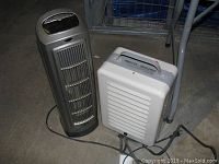 Photo of two space heaters on a floor showing overall condition and details.