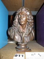 Front view of patinated metal bust showing full figure and pedestal