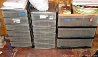 Three Sterlite storage bins: one on casters with three drawers, one multi-drawer unit labeled for batteries, and a larger two-drawer unit.