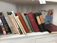 Shelf of books related to Boston and New England, showing titles about Boston, Massachusetts history, Harvard College yearbook, and other local interest topics.