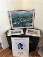 Multiple framed artworks displayed together: aerial photo, Poe Cottage sketch, colored historic estate artwork (Mount Vernon or White House), and blueprint print of The Pavilion.