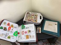 Three sample books of vintage salesman samples including keychains and various small promotional items
