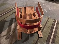 Photo from top angle showing wooden slats and curved rails with red accent