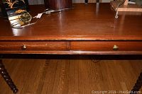 Front view showing two drawers with brass pulls beneath the tabletop and wood grain surface.