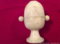 Front view of the white soapstone viewer showing knob and smooth surface.