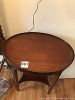 Oval mahogany end table top view showing smooth surface and subtle wood grain.