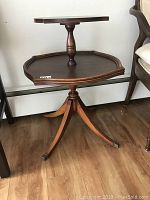 Front-side view of two-tier end table showing both tiers and pedestal base