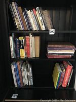 Books arranged on shelves, including titles on painting, design, and art reference books.