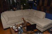 Full view of beige L-shaped sectional in room