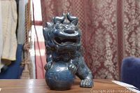 Front angled view of the blue ceramic Foo Dog showing facial details and ball under paw.