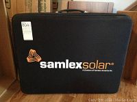Front view of the black carrying case with Samlex Solar logo and handle on top.