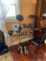 Front angle showing full electric drum set with foot pedals and control panel