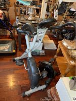 Confidence exercise bike from a front-side angle showing seat, handlebars, and flywheel housing with a label number 434.