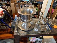 Photo showcasing the silver-plate champagne bucket, candlesticks, and large embossed Reed and Barton tray on a table.