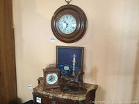 Showing full view of the German wall clock, bracket clock, painting, and wooden horse