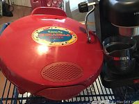 Photo of red Santa Fe brand quesadilla maker with handle and grill design on top.