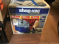 Front view of Shop Vac Contractor heavy duty portable wet/dry vacuum in original box showing brand, specs 11.5 amps, 5.5 HP, 5 gallon capacity