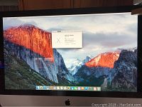 Front view showing 27-inch display powered on with OS X El Capitan