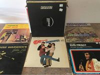 Group of vinyl LP records including 'Circulation,' 'Today's Top Hits,' 'The Monkees Headquarters,' 'Elvis Presley,' and 'The Osmonds' albums.