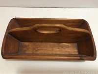 Top-down view showing the two long sections separated by a central wooden divider with an oval cutout handle.