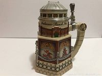 Front side view of Budweiser Collectors Club stein showing detailed artwork including Anheuser-Busch Inc. building signage and scenes with Clydesdales horses.