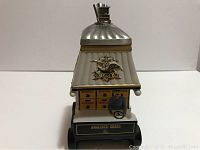 Front view showing the driver figure, wagon styled body with Budweiser crates, and pewter lid with lantern detail.