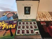 Photo of seven LP records showing covers of Dan Fogelberg, Disco Fever compilation, Princetta, Ruby Dee Dixon, and several other albums.
