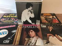 Front and angled view of six visible LP album covers, including Jane Olivor, Charlene, Tina Turner, K-Tel Hit Machine compilation, Goldie & the Gingerbreads, and CBS Music logo album.