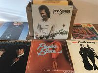 Photo showing a group of five vinyl LP album covers including John Stewart, Powder Blues, Chad & Jeremy, and a partial view of Foster and Gordon album, also partially showing Elvis LP.