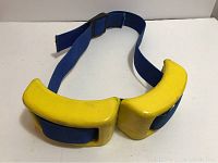 Photo of the two yellow dive weights attached to the blue adjustable belt showing the overall set condition and structure.