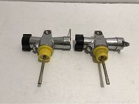 Two Nemrod J valves side by side on plain white background showing full valves including yellow handles, metal rods and adjustment knobs.