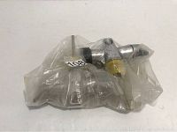 Two Nemrod J valves wrapped in plastic packaging, showing one valve with a yellow knob and chrome finish.