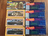 Top view showing boxed train cars from brands Athearn, LifeLike, and Roundhouse, with visible label details and logos on boxes.
