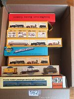 Box with multiple train car boxes inside, showing various brands and models stacked