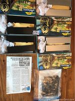 Top-down photo showing two Walthers chassis kits in boxes with components and instruction sheets laid out, plus plastic parts bags.