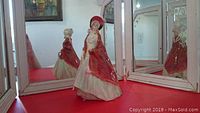 Full view of the Royal Doulton Paisley Shawl figurine displayed against mirrored background showing front and side profiles.