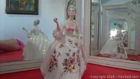 Front and side views of the Royal Doulton Diana figurine showing detailed floral decorations on white gown and holding pink shawl.