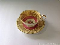View of Aynsley cup and saucer showing outer decoration and handle.