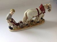 Front-left side view of the ploughman and horse porcelain figurine on base