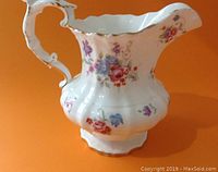 Front and side view of the Hammersley bone china pitcher showing vivid floral patterns and gold trim
