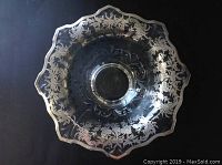 Top-down view showing large crystal bowl with sterling silver floral and leaf patterned overlay around scalloped rim.
