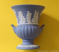 Full view of Wedgwood blue urn with white classical scene appliques and fluted lower body