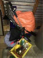 Overview photo showing crate of items, shovel, and folded tarps